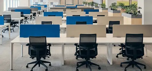 Modern open-plan office space featuring clean workstations, ergonomic chairs, and sanitized carpets provided by professional office cleaning services in Memphis, TN.